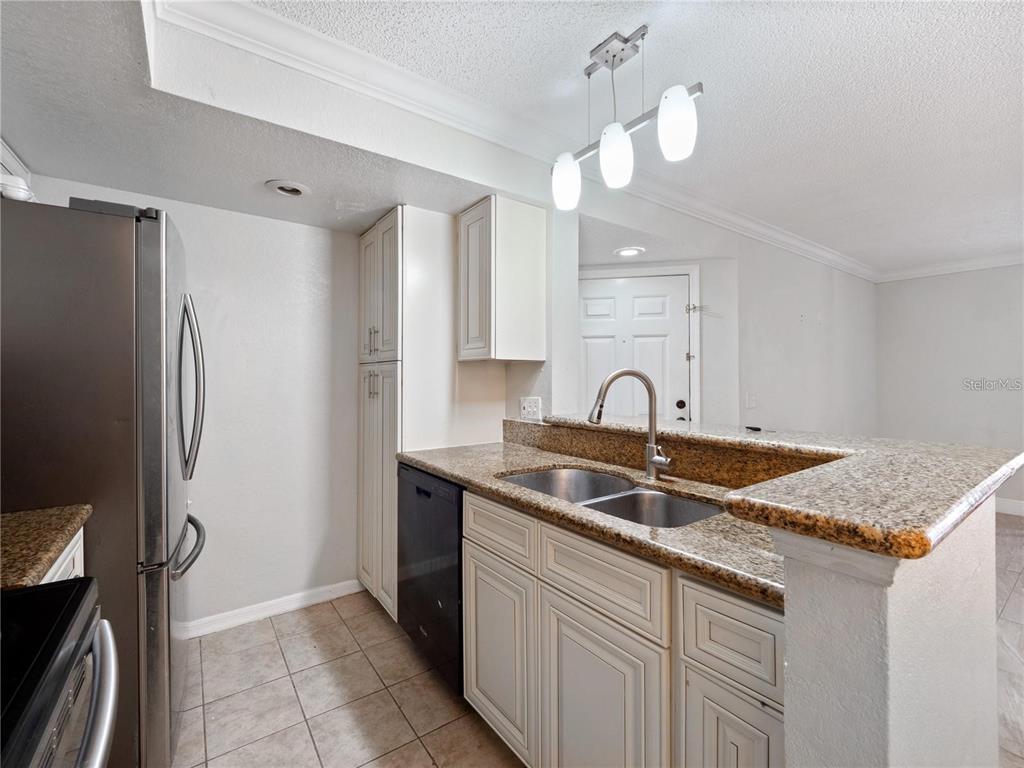 5144 Conroy Road, Unit 27 Orlando, FL 32811 - Photo 6 of 20 a close view of a sink and a refrigerator in a kitchen