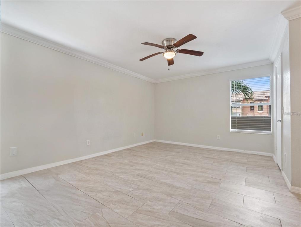 5144 Conroy Road, Unit 27 Orlando, FL 32811 - Photo 8 of 20 wooden floor in an empty room with a window