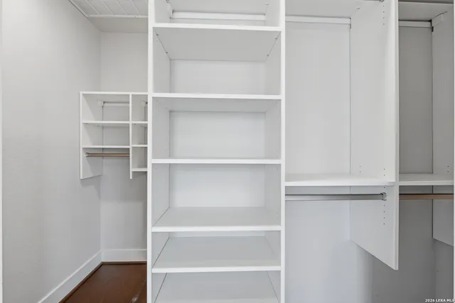 a view of walk in closet with empty racks