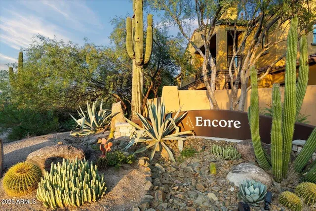 a sign that is sitting on a brick wall