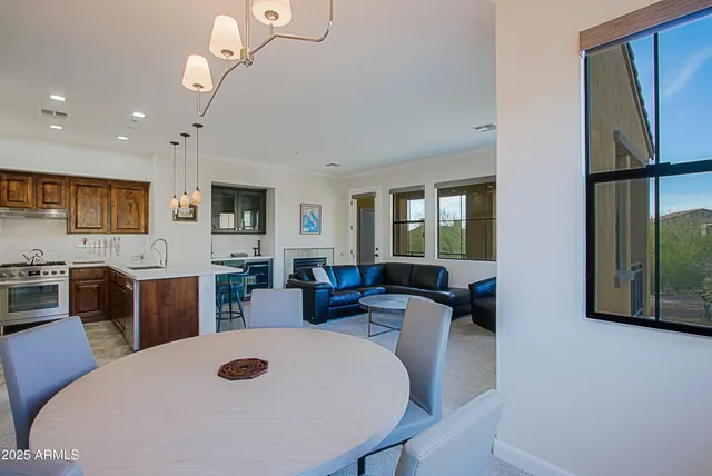 a living room with furniture fireplace and a large window