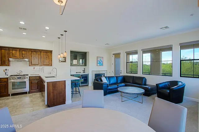 a living room with furniture and a dining table with kitchen view
