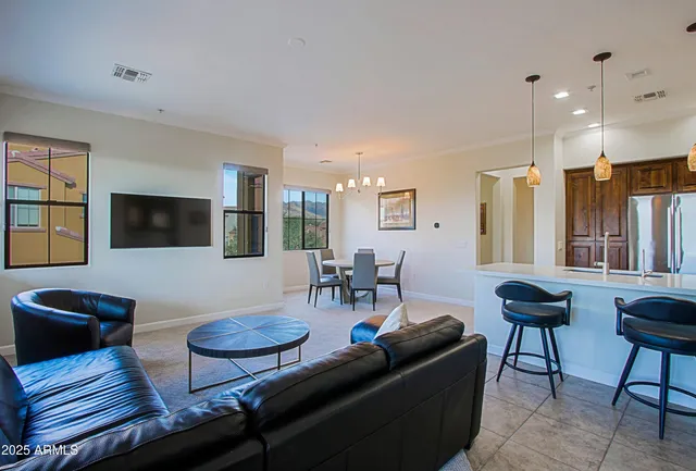 a balcony with table and chairs