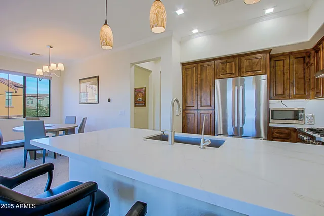 a dining room with furniture a chandelier and window