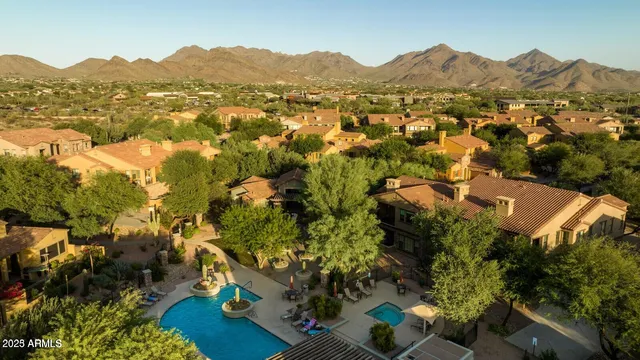 a swimming pool with outdoor seating and barbeque oven
