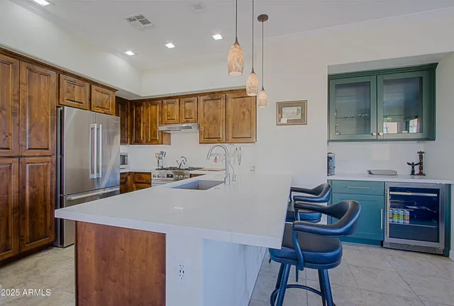 a kitchen with granite countertop a refrigerator and a sink
