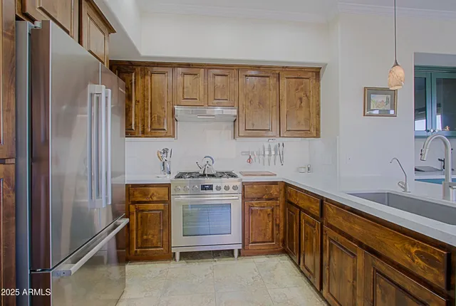 a kitchen with a refrigerator and a stove