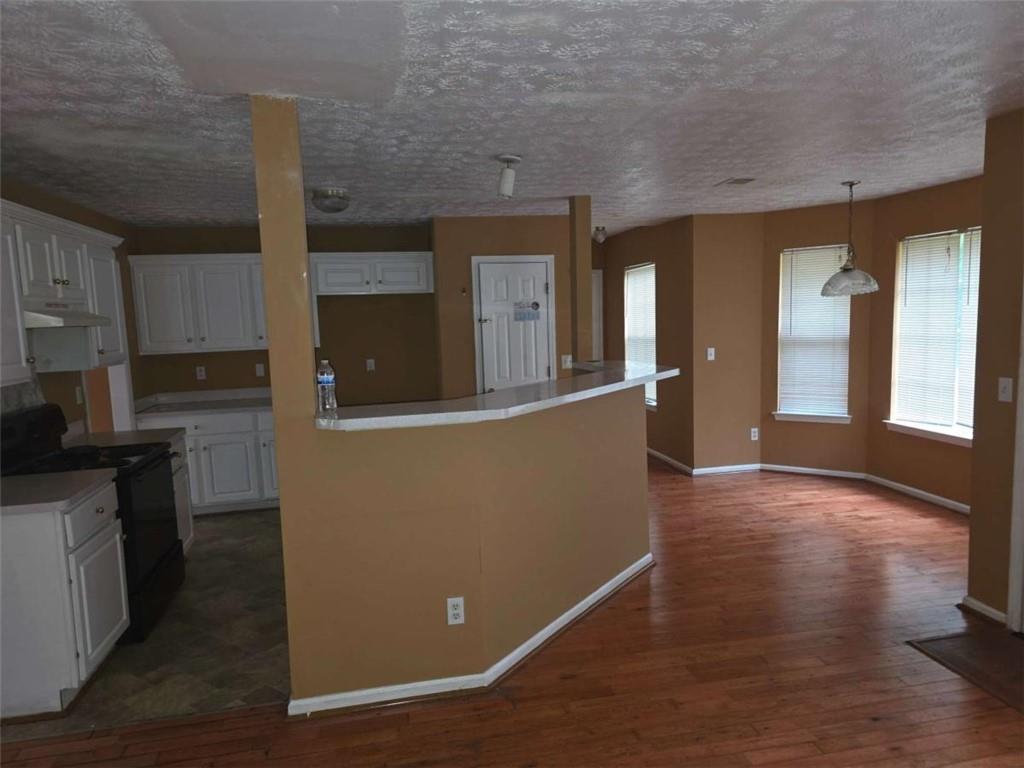 4410 Cross Lane Decatur, GA 30035 - Photo 7 of 26 a view of a kitchen with furniture and wooden floor