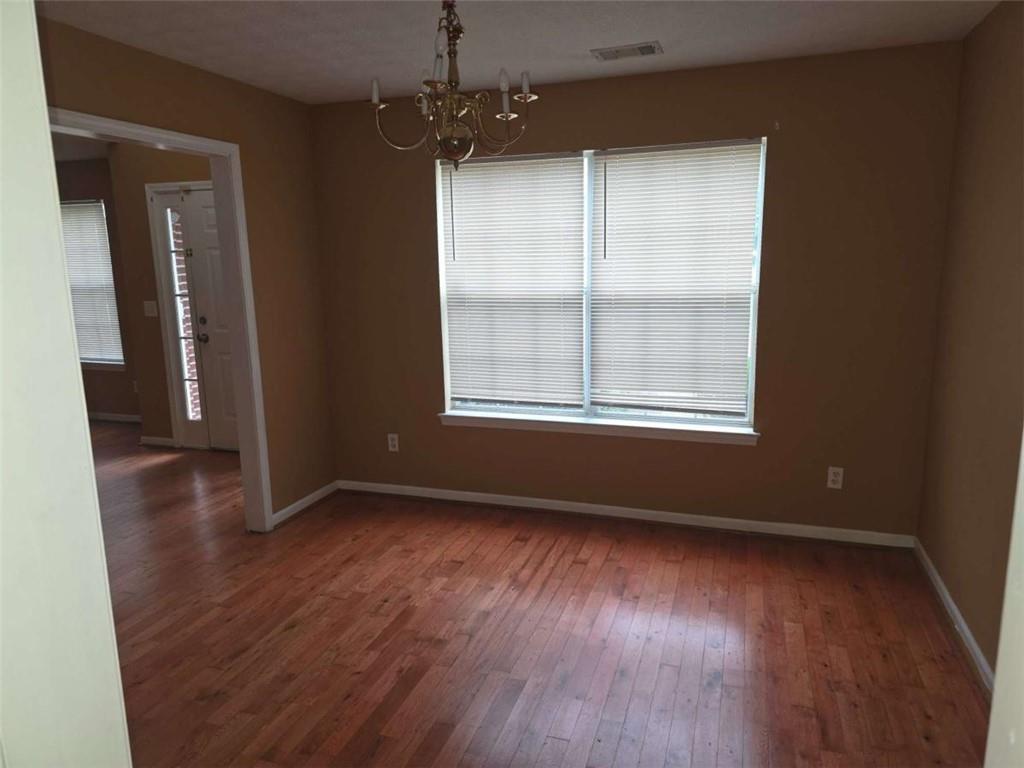 4410 Cross Lane Decatur, GA 30035 - Photo 8 of 26 an empty room with wooden floor and windows