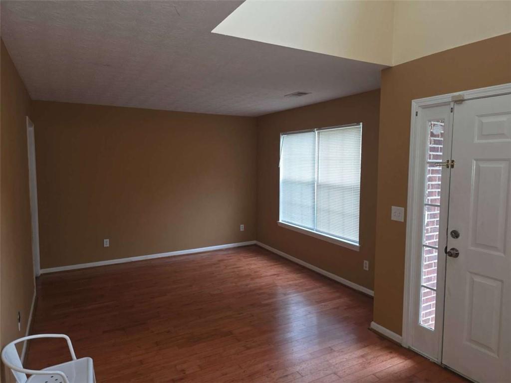 4410 Cross Lane Decatur, GA 30035 - Photo 9 of 26 an empty room with wooden floor and windows