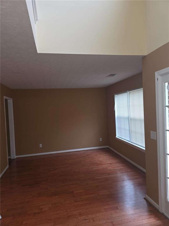 4410 Cross Lane Decatur, GA 30035 - Photo 10 of 26 a view of an empty room with wooden floor and a window
