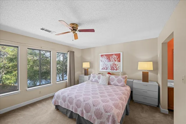 a bedroom with a large bed and a chandelier