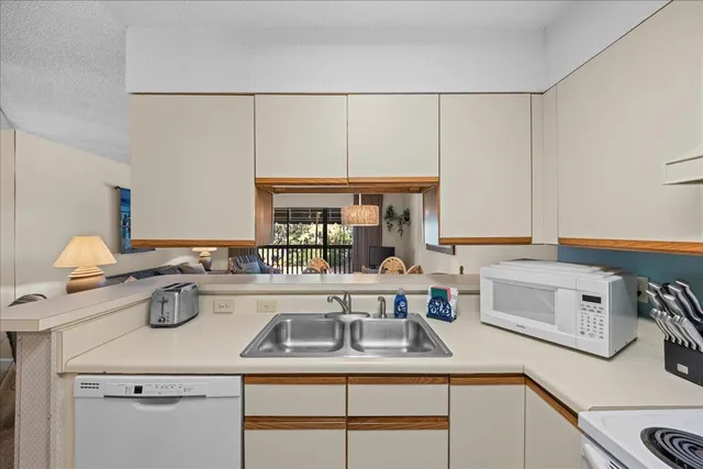 a kitchen with a sink and a stove top oven