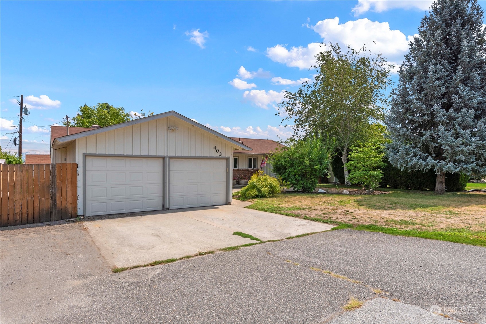 403 Marilyn Avenue Wenatchee, WA 98801 - Photo 2 of 24 a view of a house with a yard and garage