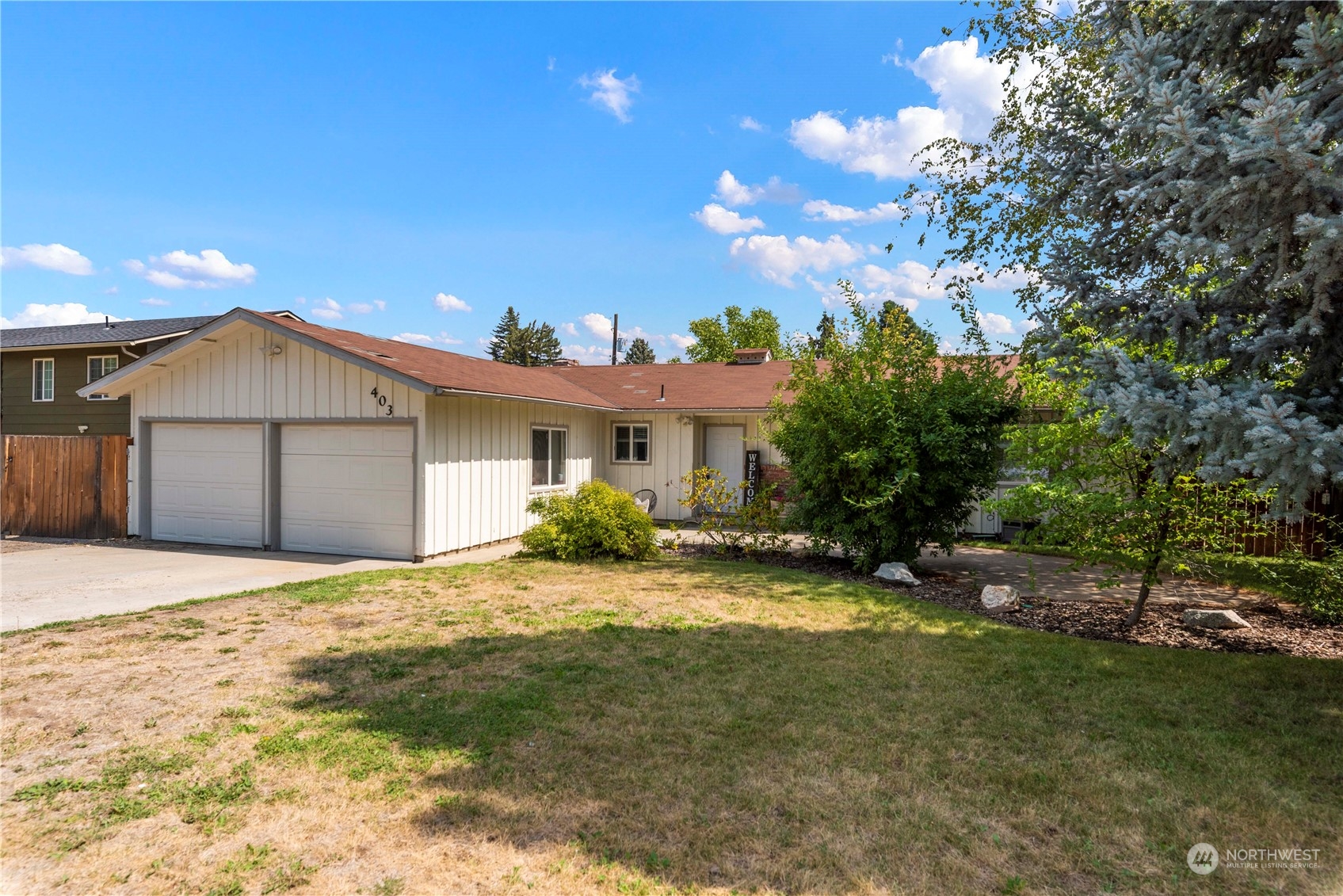 403 Marilyn Avenue Wenatchee, WA 98801 - Photo 24 of 24 a front view of a house with a yard and garage