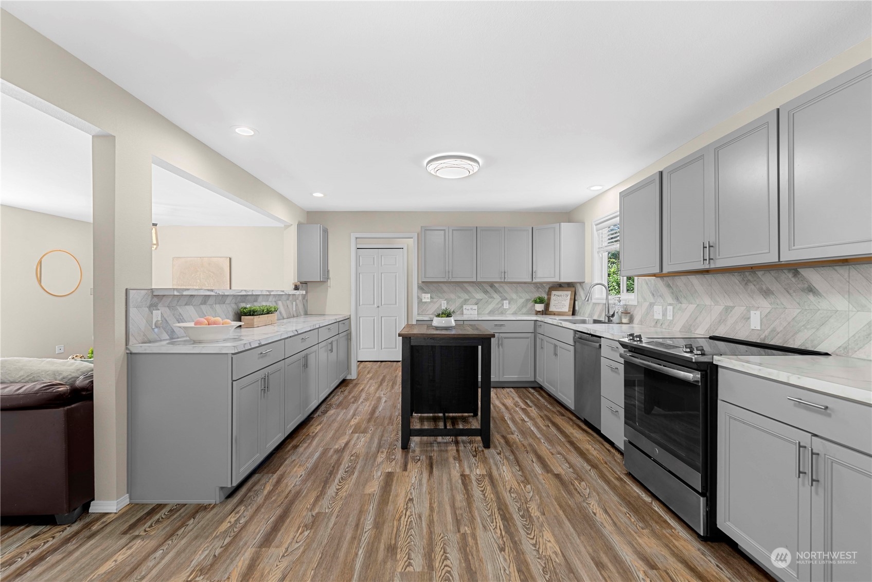 403 Marilyn Avenue Wenatchee, WA 98801 - Photo 9 of 24 a kitchen with a sink cabinets wooden floor and stainless steel appliances