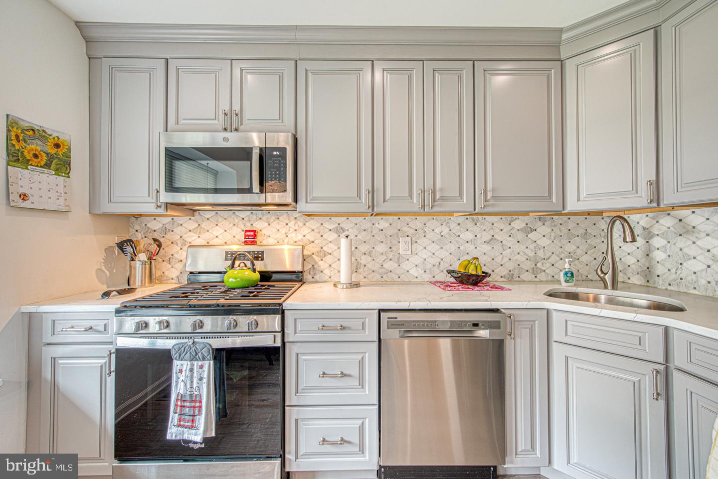 333 Scola Road Brookhaven, PA 19015 - Photo 12 of 57 a kitchen with stainless steel appliances granite countertop a sink stove and cabinets