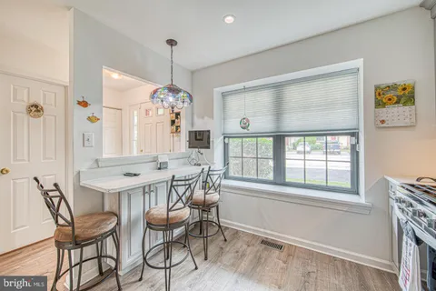 a dining room with furniture a chandelier and a rug