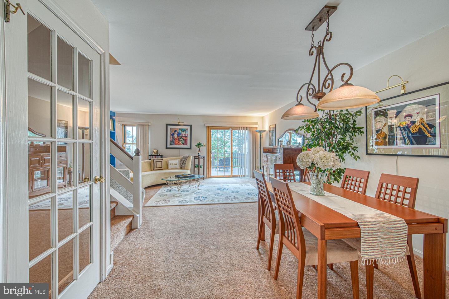 333 Scola Road Brookhaven, PA 19015 - Photo 14 of 57 a dining room with furniture a chandelier and a rug
