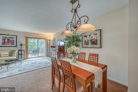 a view of a dining room with furniture wooden floor and chandelier
