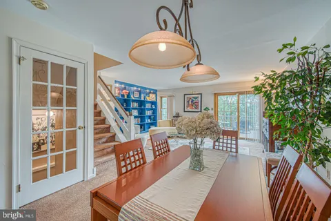 a living room with fireplace furniture and a book shelf