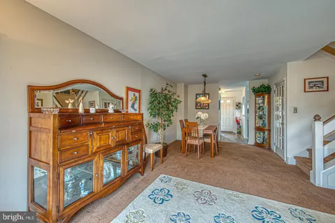 a living room with furniture and a book shelf