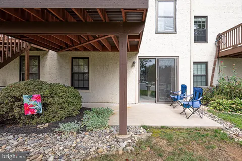 a view of a balcony with wooden floor and seating space