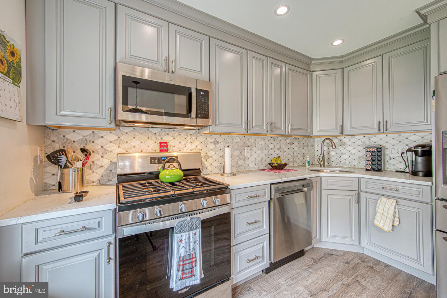 333 Scola Road Brookhaven, PA 19015 - Photo 9 of 57 a kitchen with stainless steel appliances granite countertop a sink a stove and cabinets
