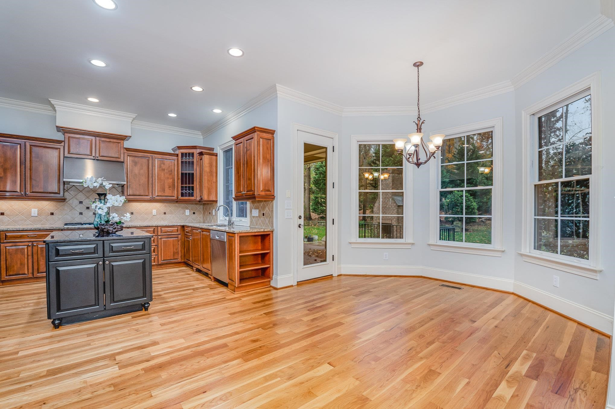1817 Silver Mist Court Raleigh, NC 27613 - Photo 12 of 40 a large kitchen with stainless steel appliances granite countertop a granite counter tops and a wooden floors