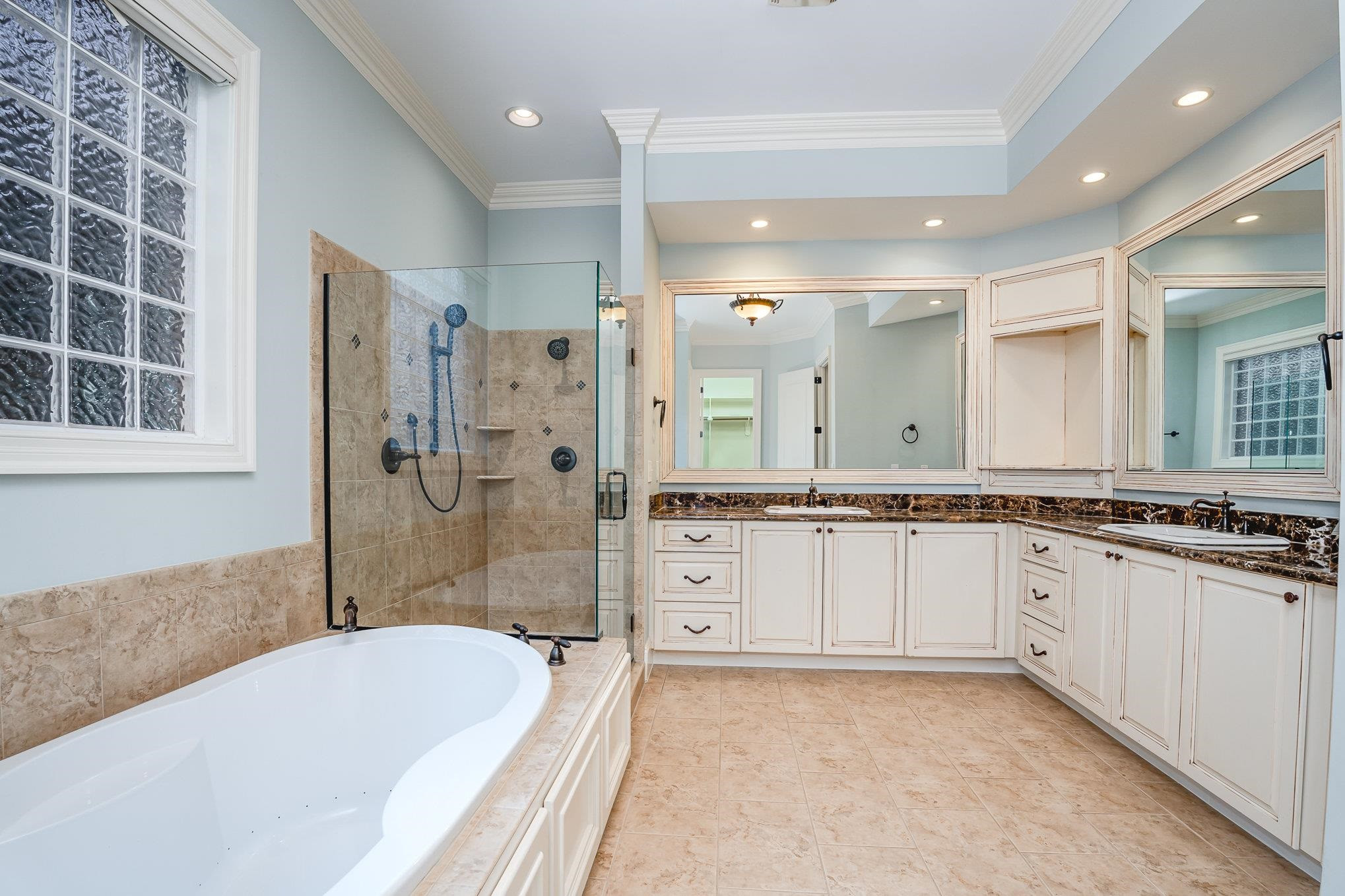 1817 Silver Mist Court Raleigh, NC 27613 - Photo 17 of 40 a spacious bathroom with a granite countertop tub sink shower and a mirror