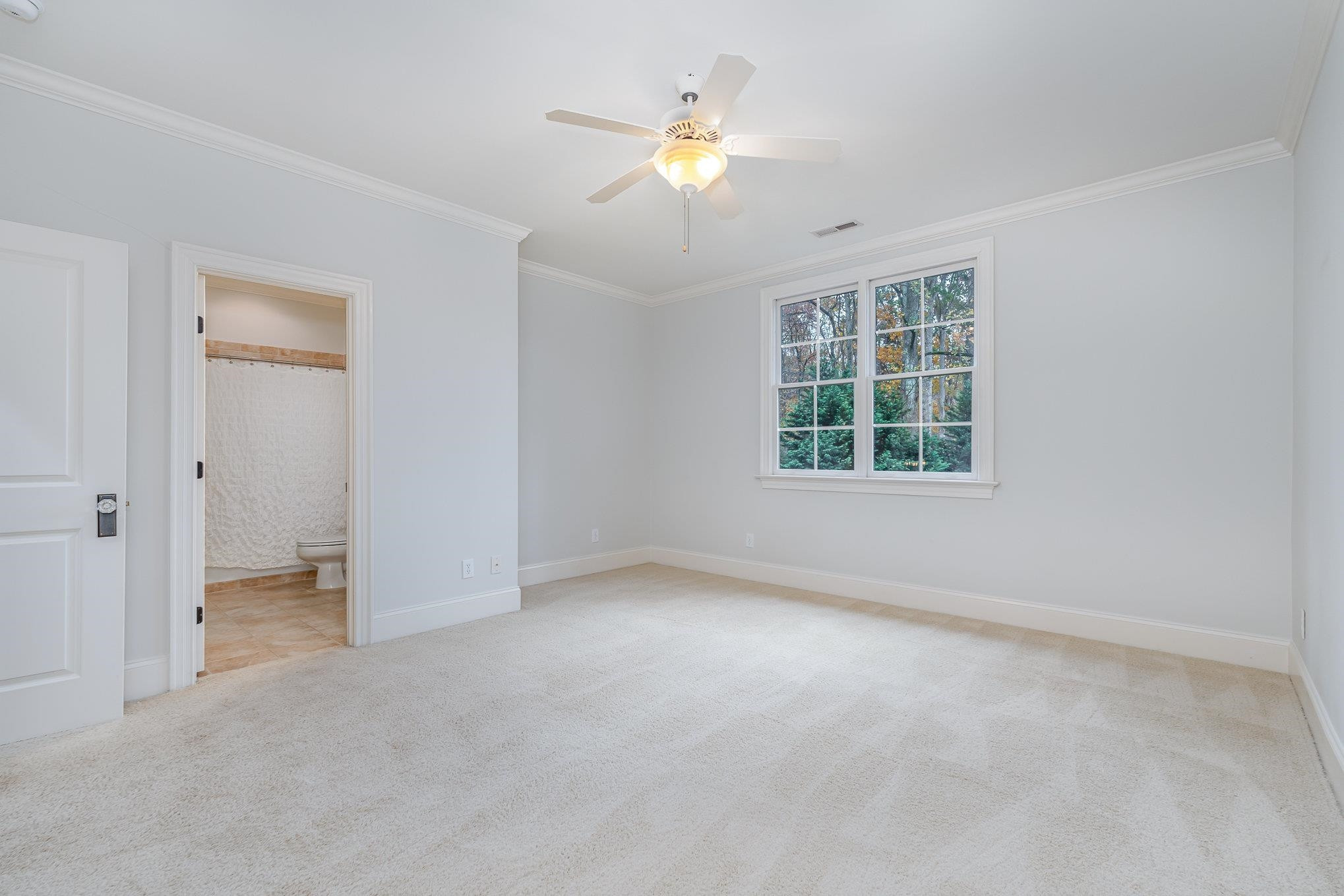 1817 Silver Mist Court Raleigh, NC 27613 - Photo 20 of 40 an empty room with chandelier fan and windows