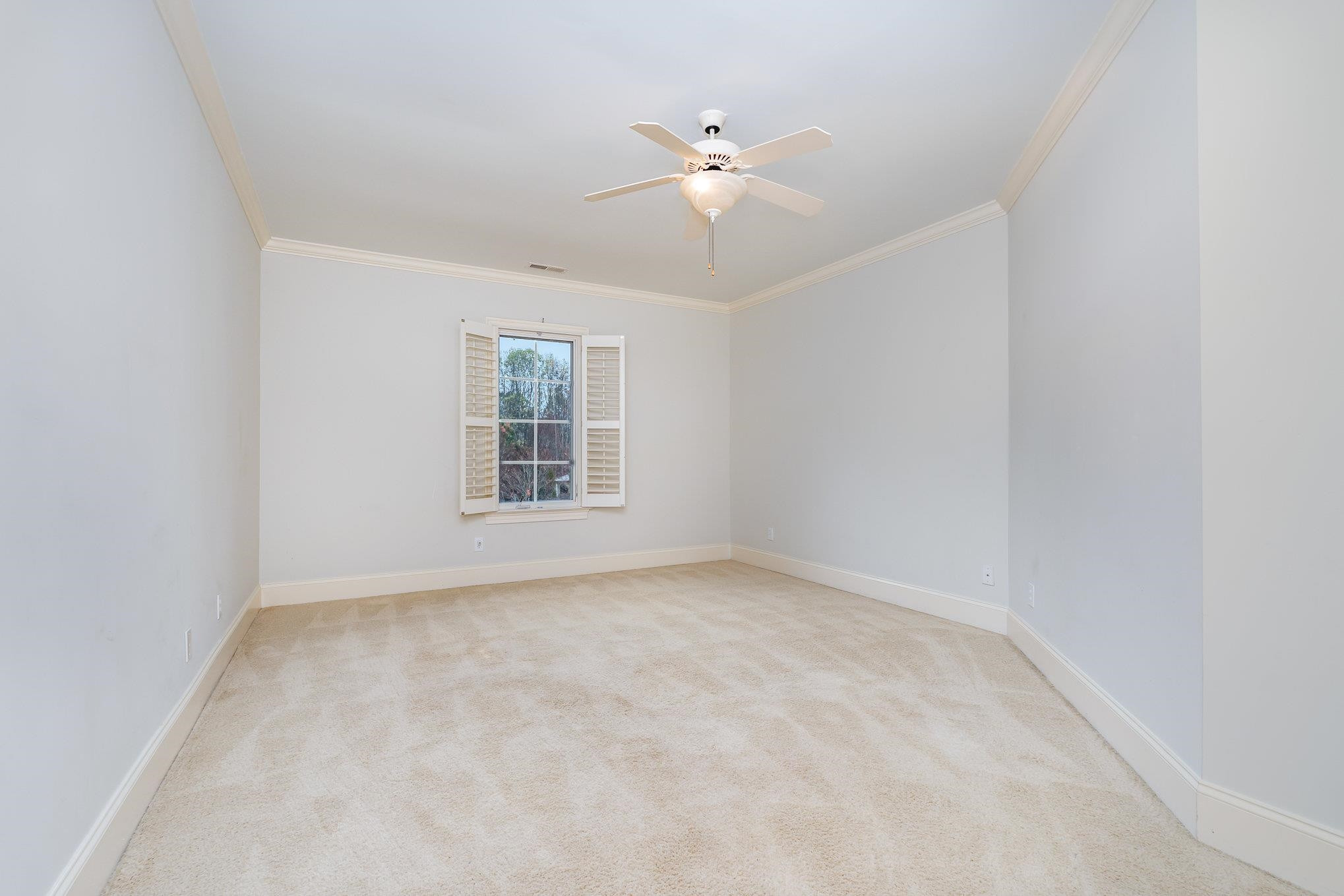1817 Silver Mist Court Raleigh, NC 27613 - Photo 22 of 40 an empty room with windows and fan