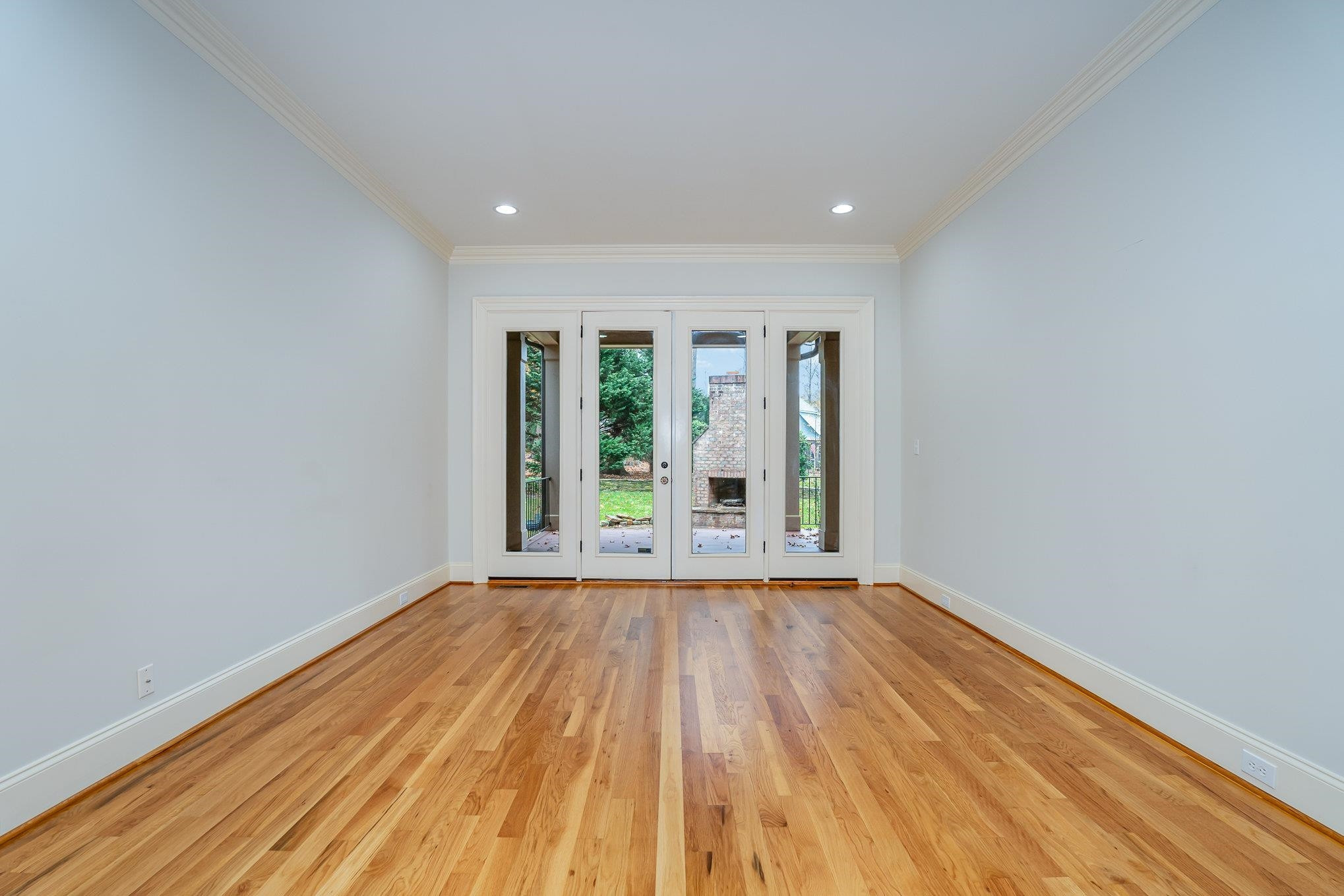 1817 Silver Mist Court Raleigh, NC 27613 - Photo 8 of 40 a view of an empty room with wooden floor and a window