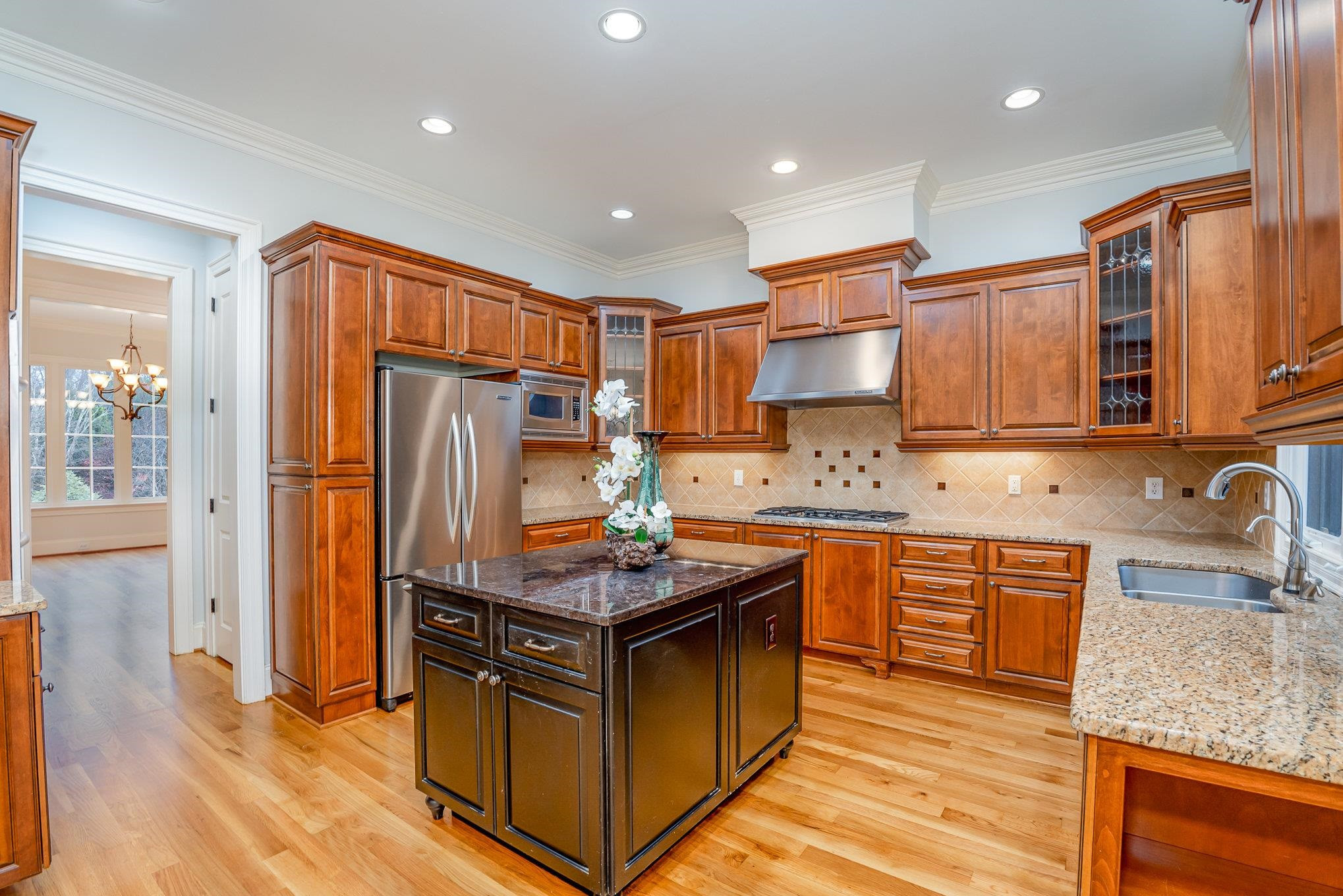 1817 Silver Mist Court Raleigh, NC 27613 - Photo 9 of 40 a kitchen with stainless steel appliances granite countertop a refrigerator a sink and a stove