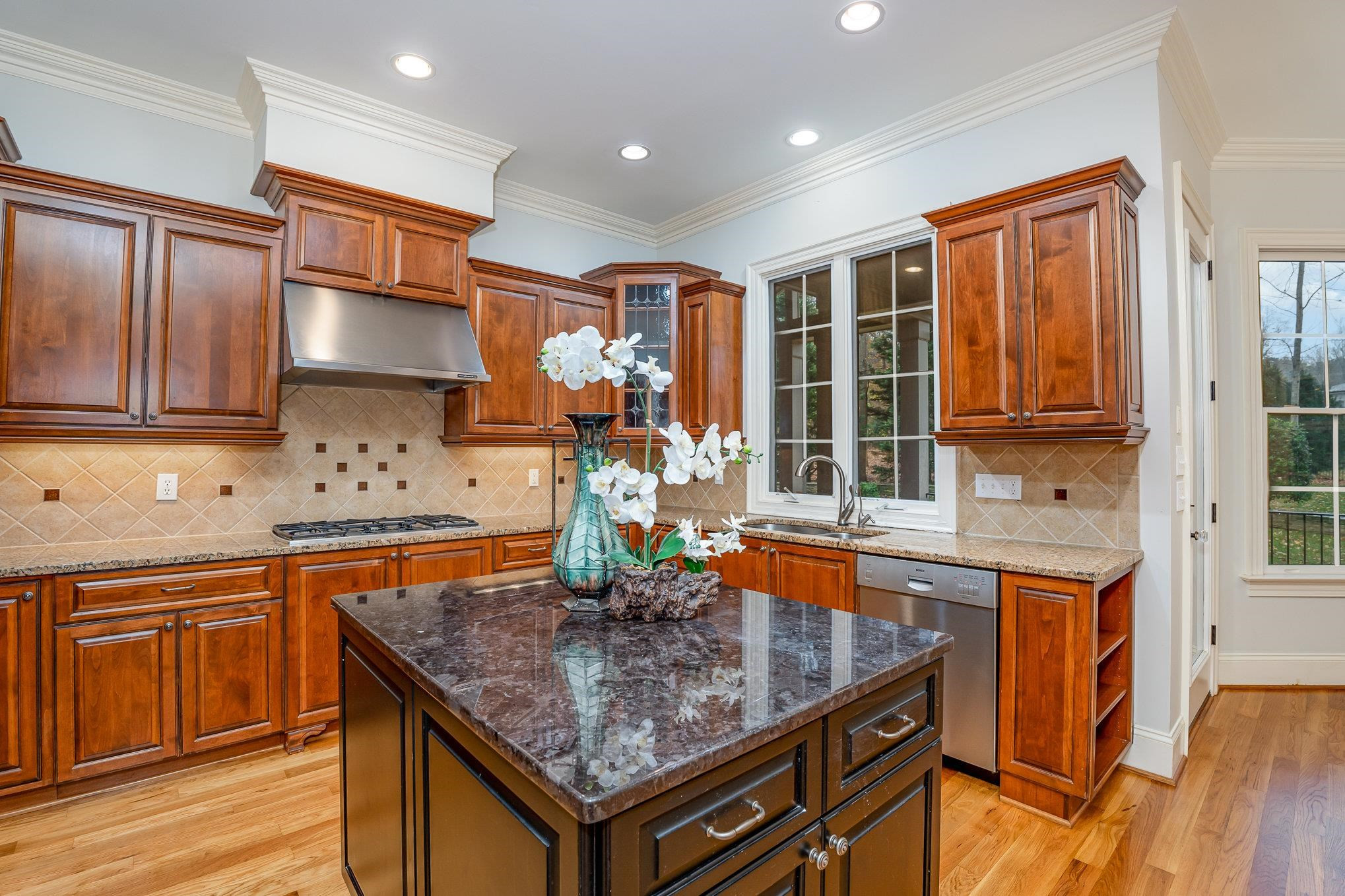 1817 Silver Mist Court Raleigh, NC 27613 - Photo 10 of 40 a kitchen with stainless steel appliances granite countertop a sink stove and cabinets