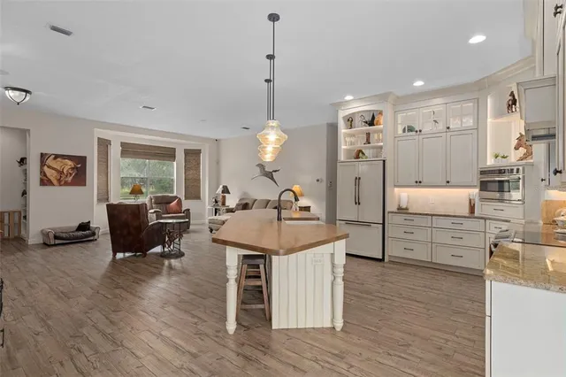 a bathroom with a granite countertop toilet sink and mirror