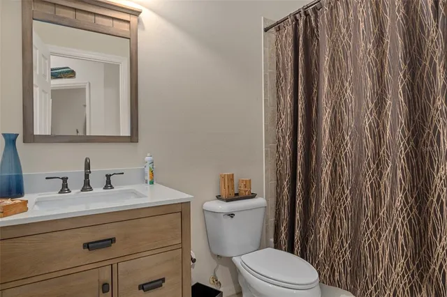 a bedroom with a bed a chandelier and a window