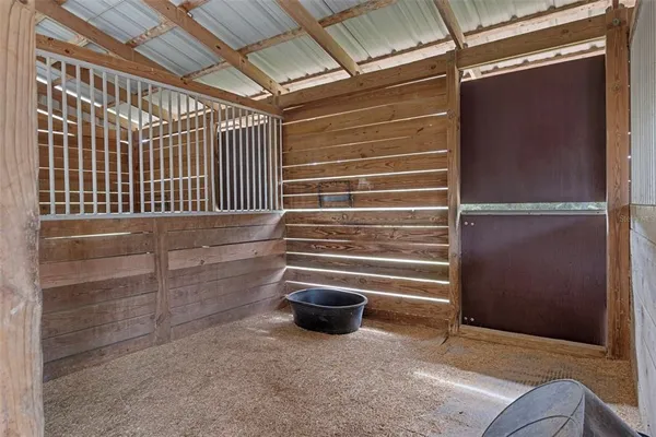 a view of a yard with wooden fence