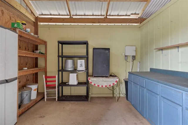 a living room with a flat screen tv and a white wall