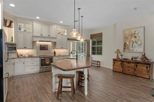 a kitchen with stainless steel appliances granite countertop a refrigerator sink and cabinets