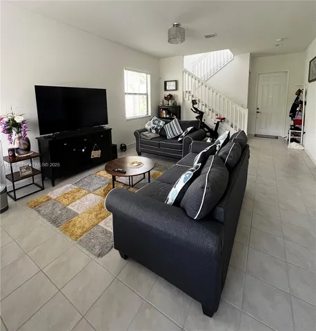 a living room with furniture and a flat screen tv