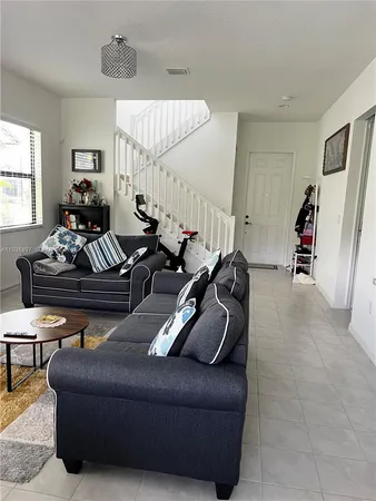 a living room with furniture a couch and a window