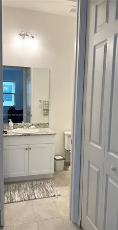 a bathroom with a sink a toilet and a mirror