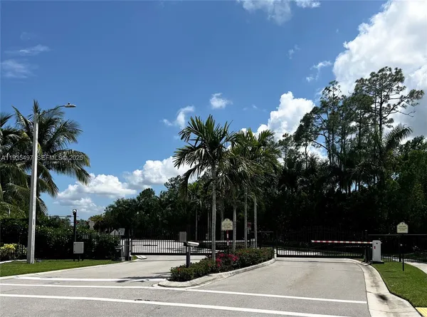 a view of swimming pool with palm trees