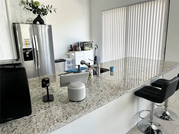 a dining room with furniture and a potted plant