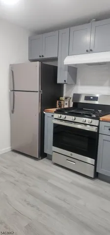a kitchen with a stove and a refrigerator