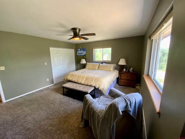 a bed room with a bed and a chandelier