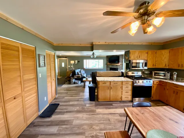 a living room with furniture and a kitchen