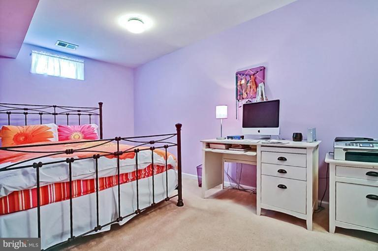 18404 Cornflower Road Boyds, MD 20841 - Photo 22 of 30 a bedroom with furniture and a flat screen tv