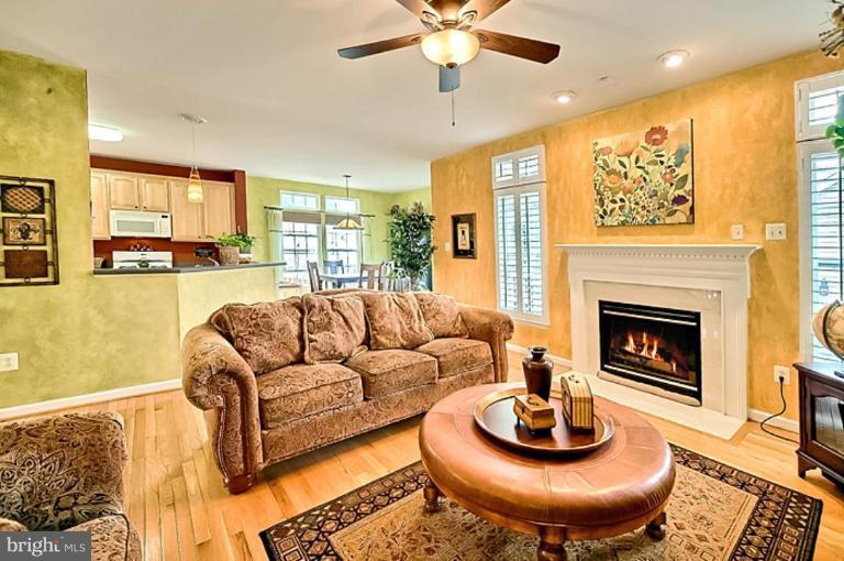 18404 Cornflower Road Boyds, MD 20841 - Photo 8 of 30 a living room with furniture a fireplace and a large window